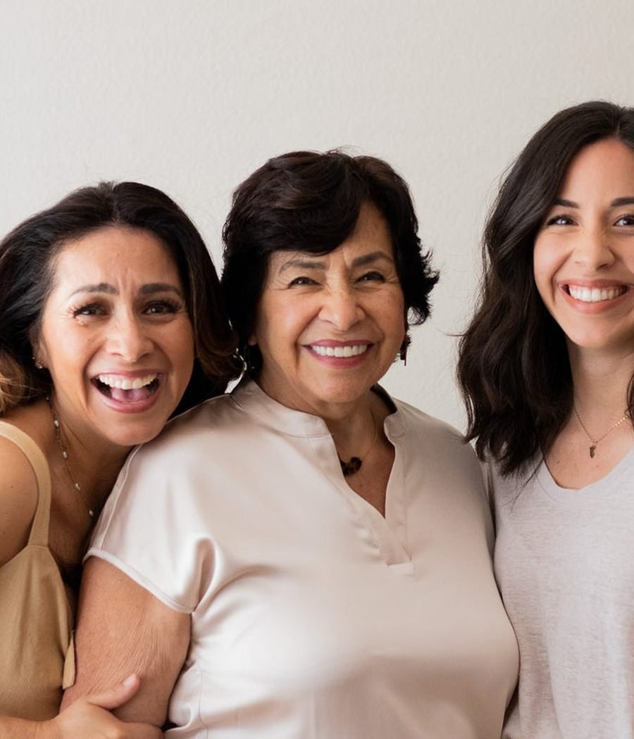 Three women standing together, arms around each other, smiling. Photo by a contributing Nappy photographer, CC0.