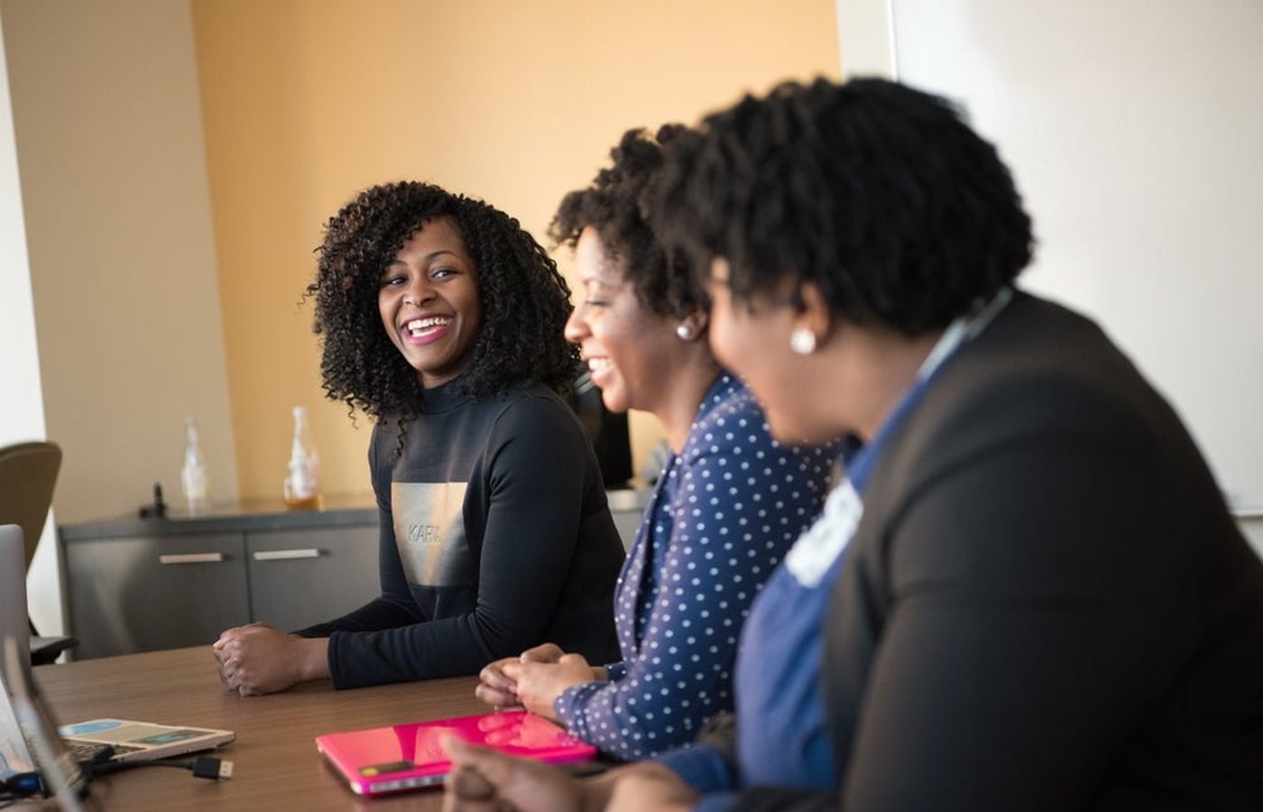Three women in conversation at a table. Photo by a contributing Nappy photographer, CC0.